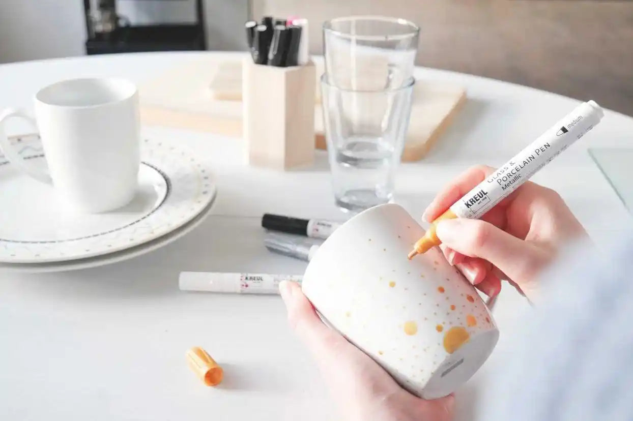 KREUL glass and porcelain pen in use on glassware and ceramic items with metallic finish