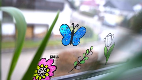 Colorful butterfly and flower window art made with KREUL Window Color Set