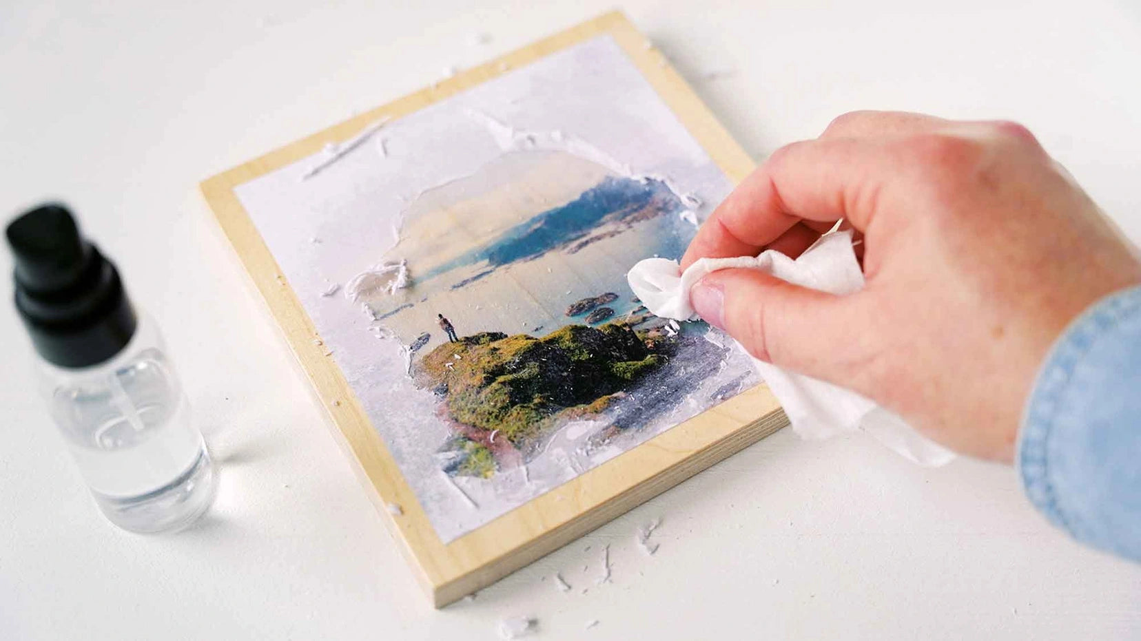 Removing paper fibers after photo transfer using KREUL Foto Transfer Potch on wood