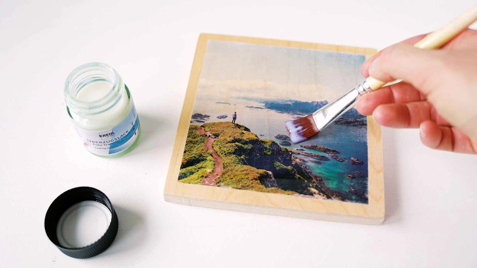 Removing paper fibers after photo transfer using KREUL Foto Transfer Potch on wood