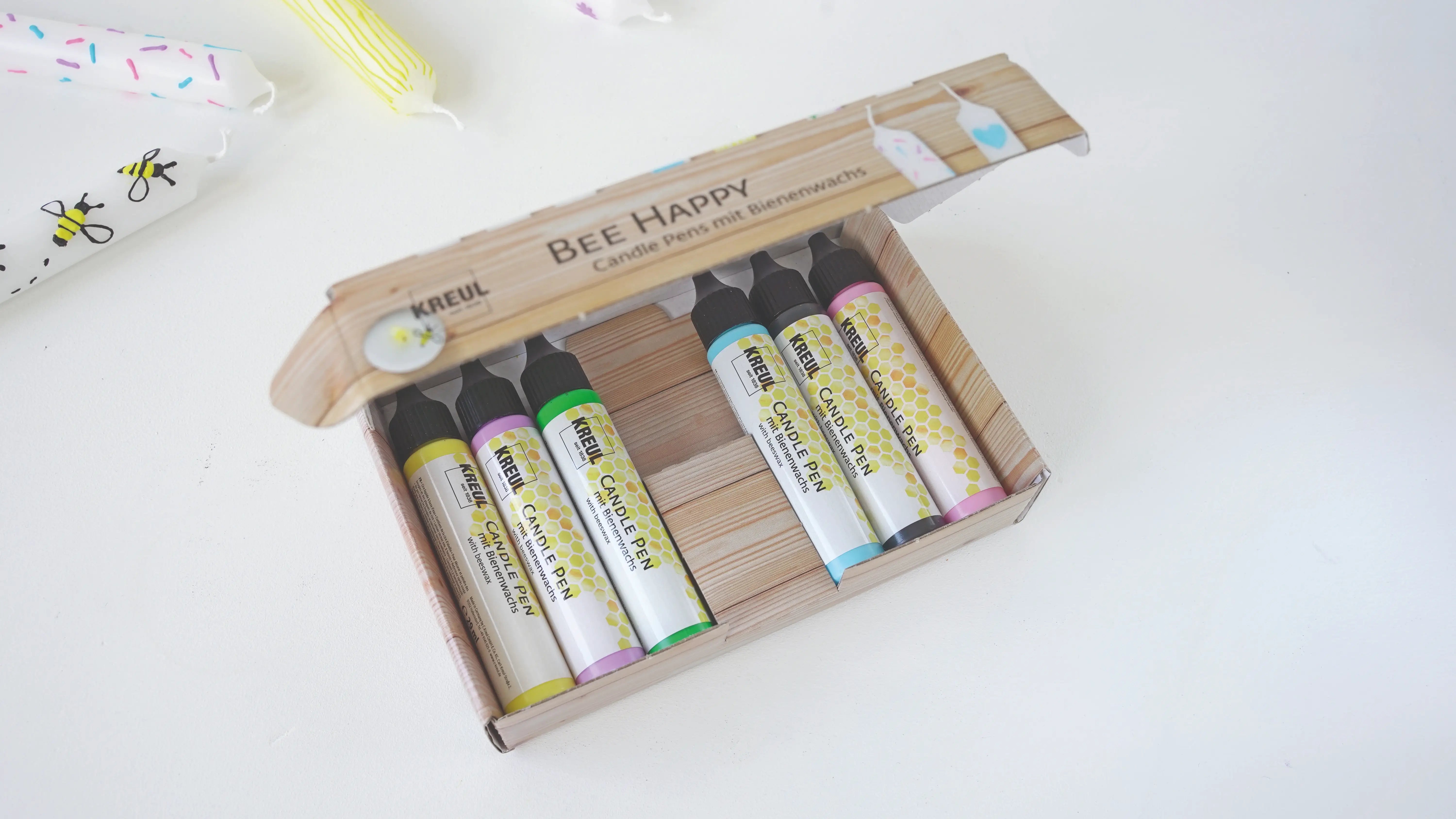 Hand-painted candles created with KREUL Bee Happy candle pens
