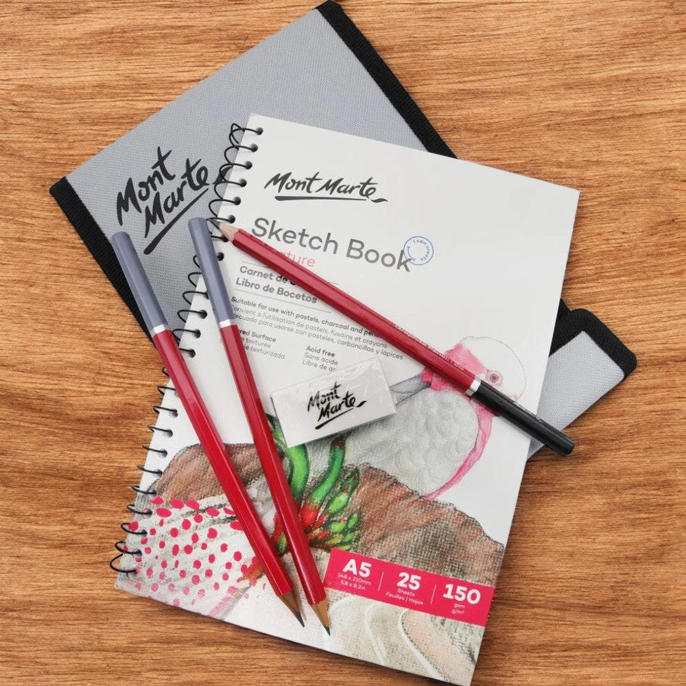 Flatlay of Mont Marte Sketching Set with Pencils, Book, and Wallet